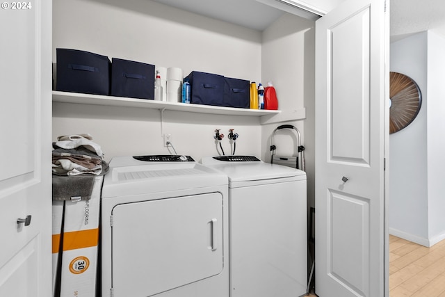 laundry area featuring light wood-type flooring and washing machine and clothes dryer