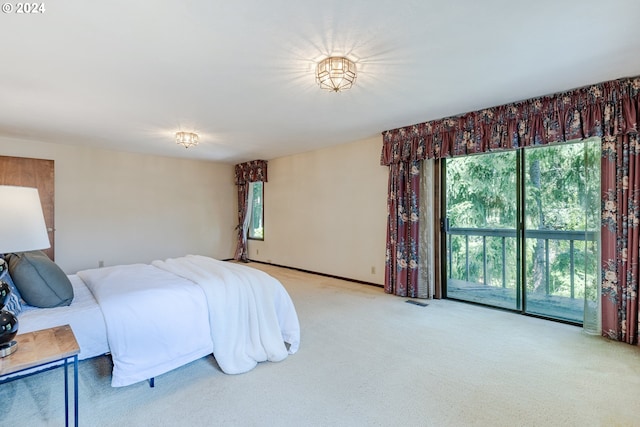 carpeted bedroom with access to exterior