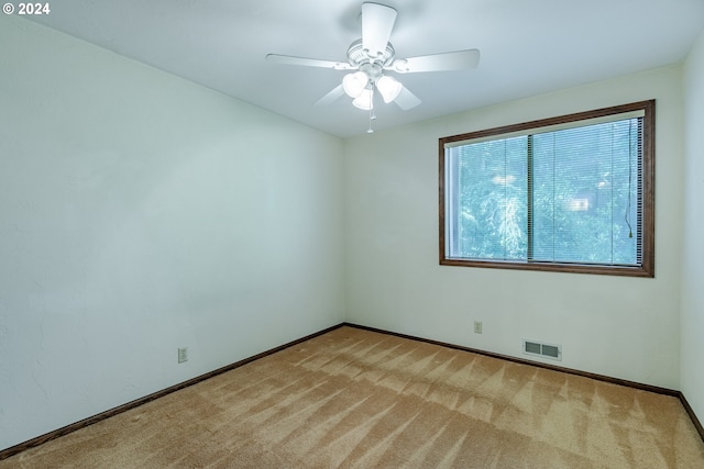 empty room featuring light carpet and ceiling fan