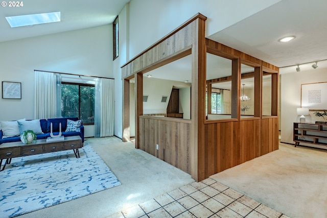 interior space with a skylight, a towering ceiling, and carpet floors