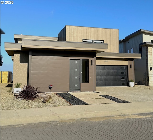 modern home featuring concrete driveway and an attached garage