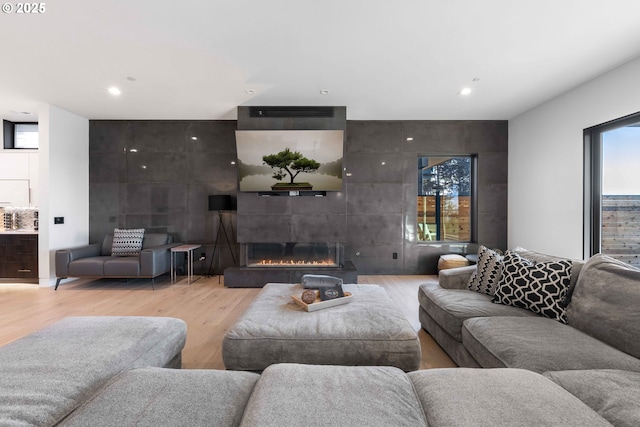 living area with a fireplace and light wood finished floors