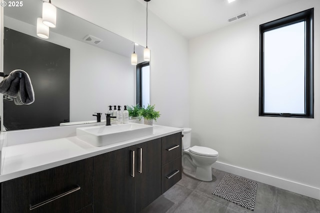 bathroom featuring visible vents, baseboards, toilet, and vanity