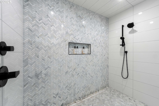 bathroom with tiled shower