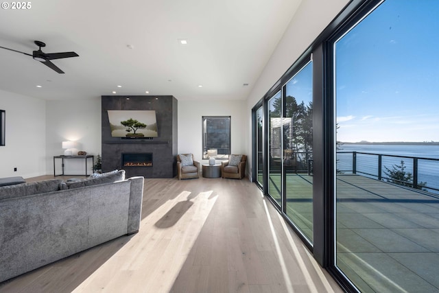 living room with ceiling fan, recessed lighting, wood finished floors, and a large fireplace