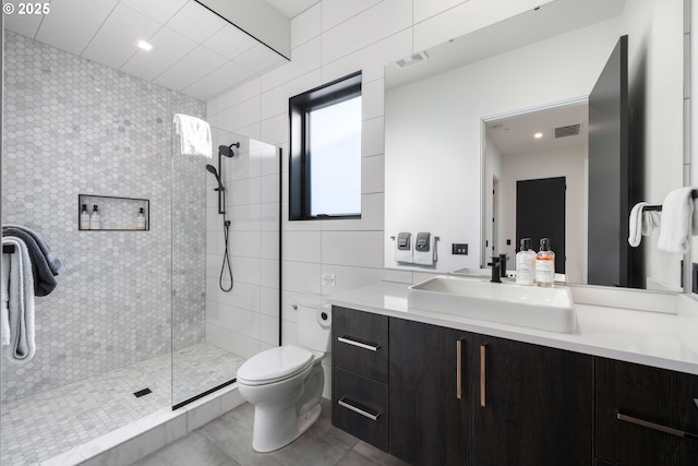 full bath featuring visible vents, walk in shower, and vanity