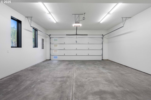 garage with electric panel and a garage door opener