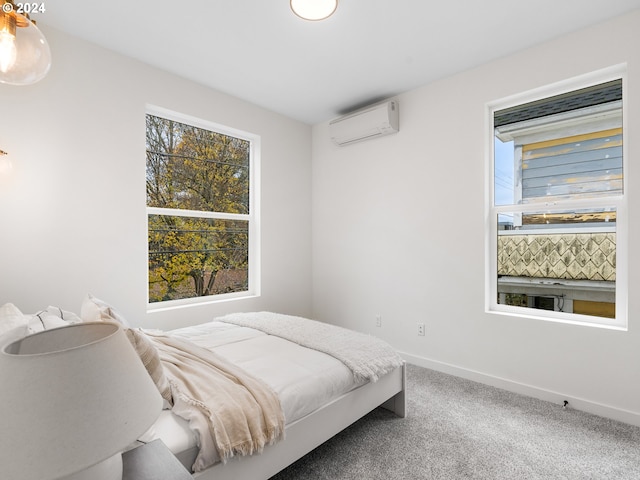 bedroom featuring carpet flooring and an AC wall unit