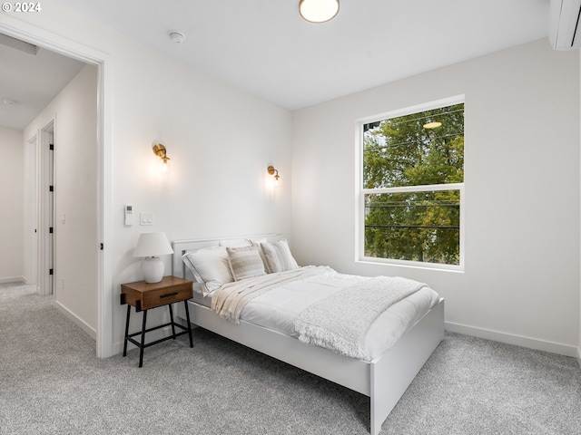 bedroom featuring carpet and a wall mounted AC