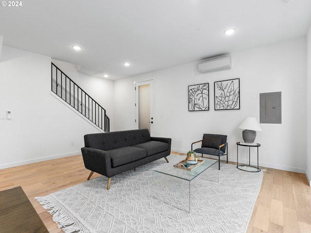 living room with hardwood / wood-style floors, electric panel, and a wall mounted AC