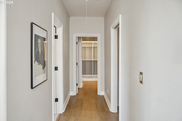 hallway with light hardwood / wood-style flooring