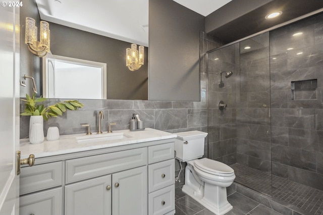 bathroom featuring tile walls, vanity, tile patterned flooring, toilet, and an enclosed shower