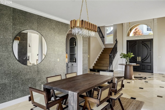 dining area with crown molding, tile patterned flooring, tile walls, and an inviting chandelier