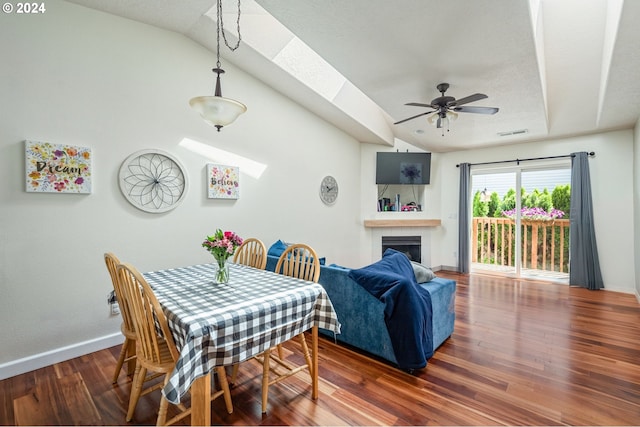 dining area featuring dark hardwood / wood-style floors, ceiling fan, and lofted ceiling