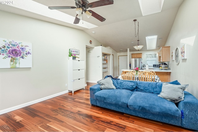 living room featuring ceiling fan, dark hardwood / wood-style flooring, and vaulted ceiling