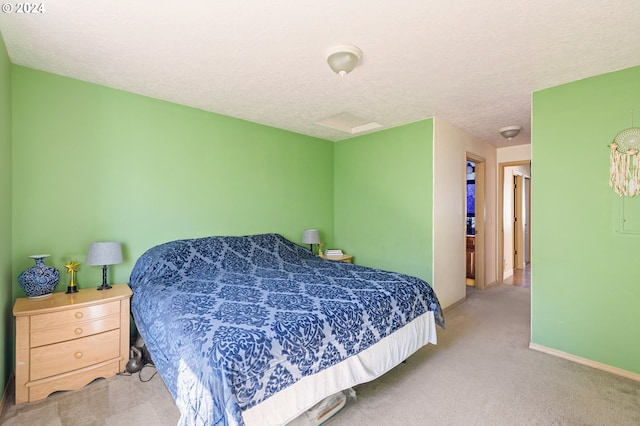 bedroom featuring a textured ceiling and light carpet