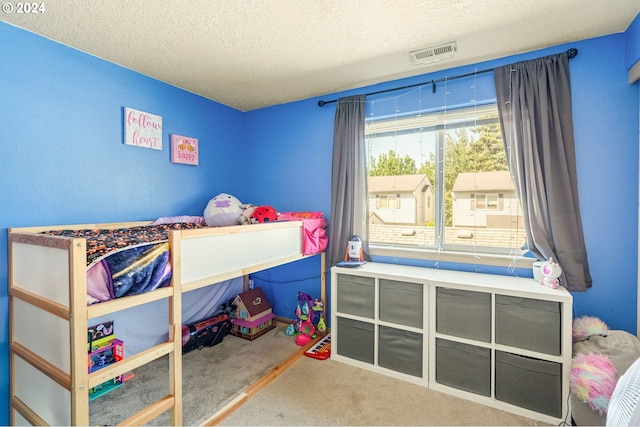 carpeted bedroom with a textured ceiling