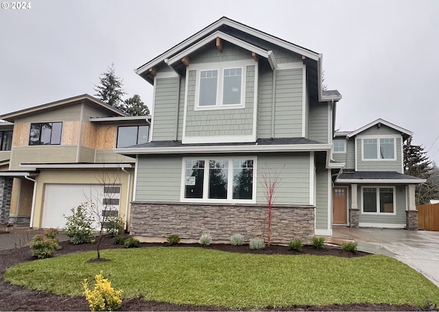 view of front of house featuring a garage and a front lawn