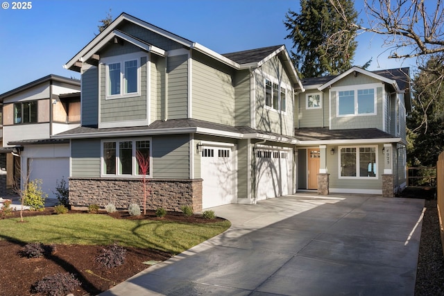 craftsman house featuring an attached garage, stone siding, and driveway