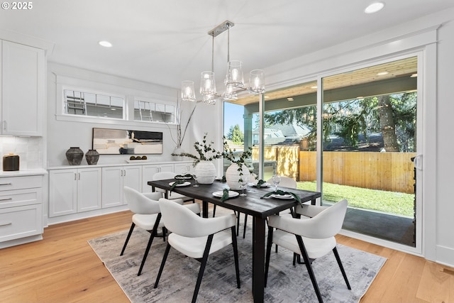 dining room featuring recessed lighting, light wood-type flooring, and a notable chandelier