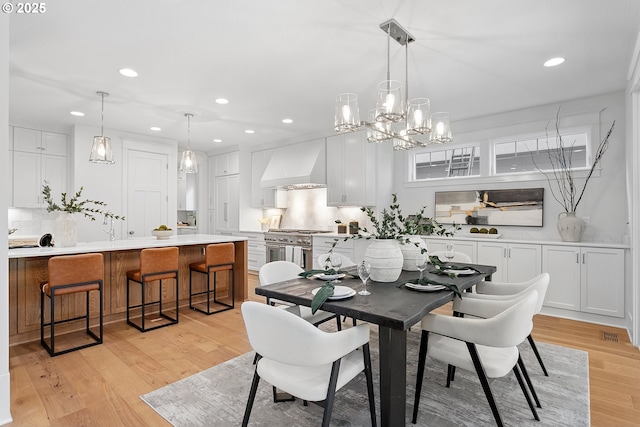 dining space with recessed lighting, visible vents, and light wood-style flooring