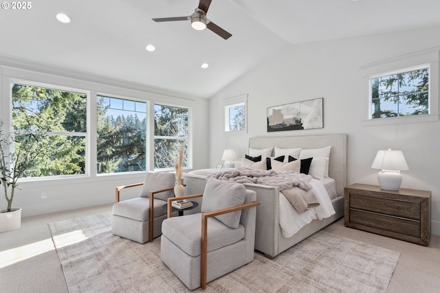 bedroom with multiple windows, light colored carpet, and lofted ceiling