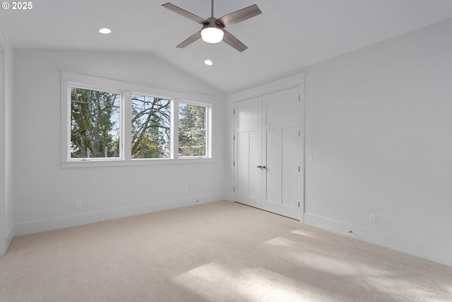 unfurnished bedroom featuring light carpet, lofted ceiling, recessed lighting, a closet, and baseboards