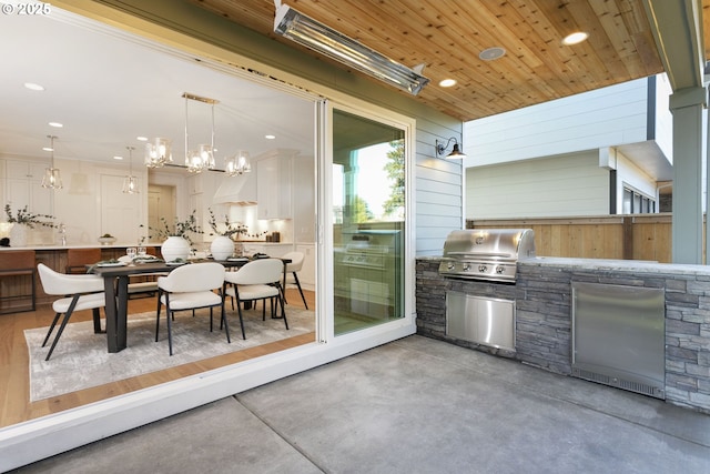 view of patio with a grill, exterior kitchen, and outdoor dining space