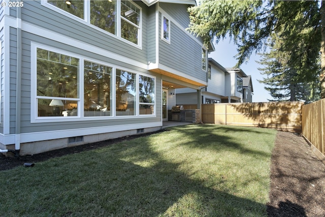 view of yard featuring a fenced backyard and visible vents