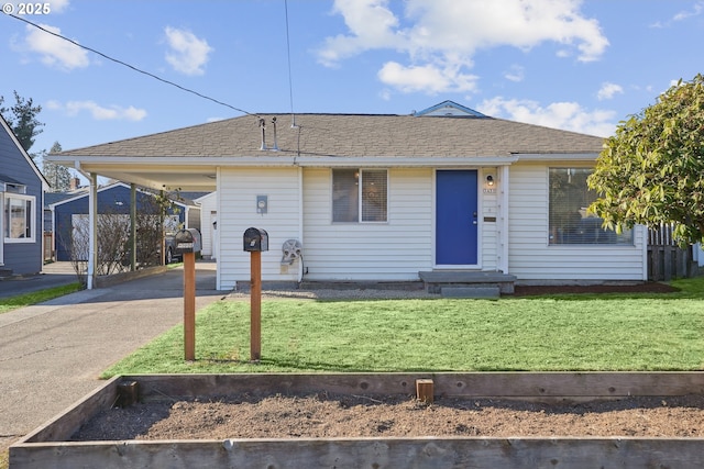 view of front of home with a front lawn and a carport