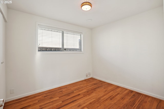 spare room with wood-type flooring