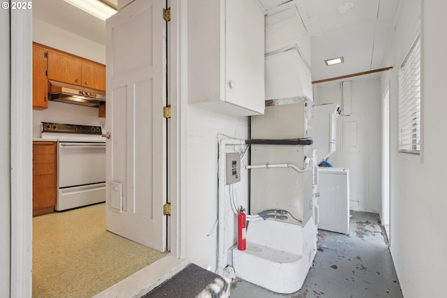 kitchen with washer / dryer and white electric range oven