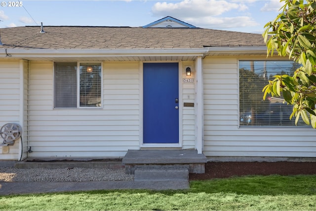 doorway to property featuring a yard