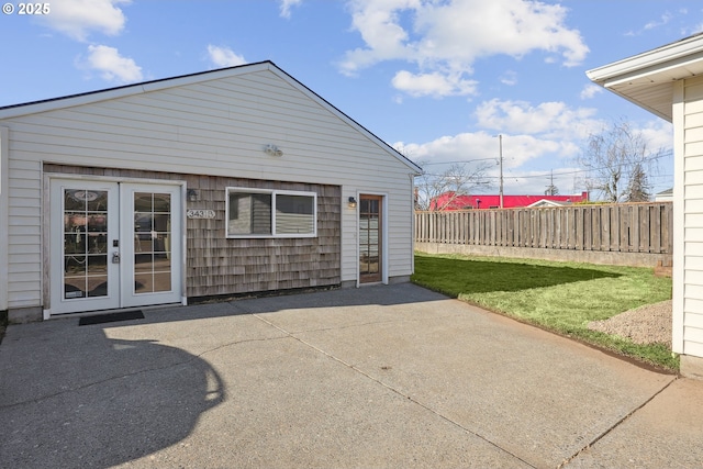 rear view of house with a patio, a yard, and french doors