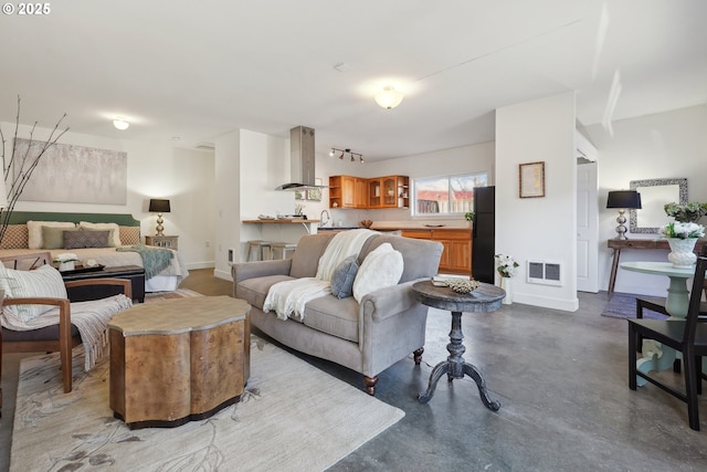 living room featuring sink and concrete flooring