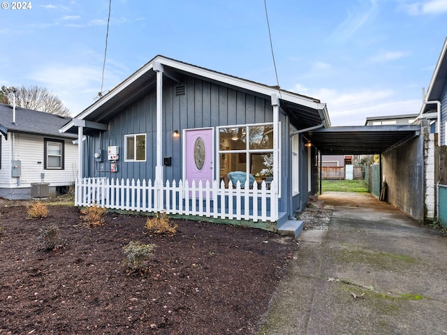 view of front of home with central AC and a carport