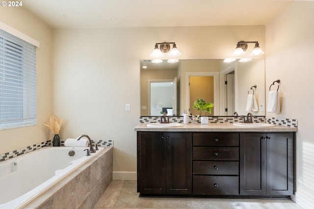 bathroom with double vanity, a garden tub, tasteful backsplash, and a sink