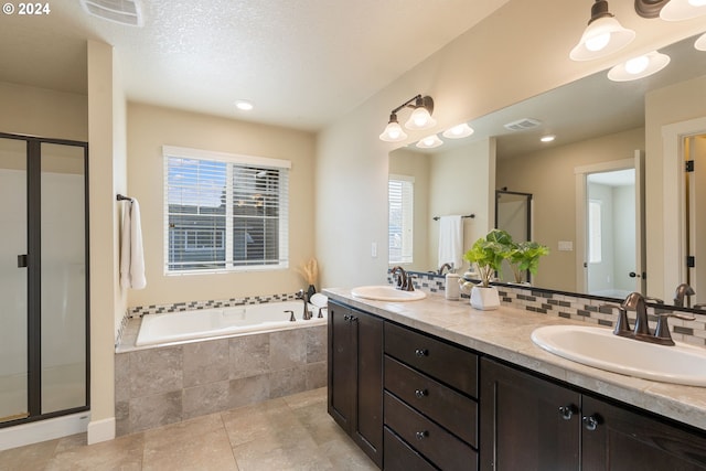 full bathroom featuring a sink, decorative backsplash, a garden tub, and a shower stall