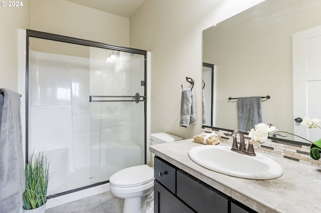 full bathroom featuring a stall shower, toilet, and vanity