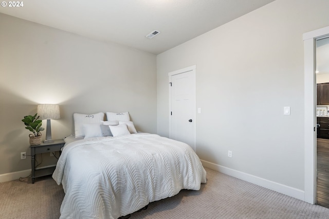 bedroom featuring baseboards, carpet floors, and visible vents