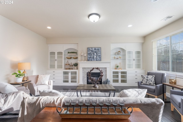 living room with recessed lighting, visible vents, wood finished floors, and a fireplace