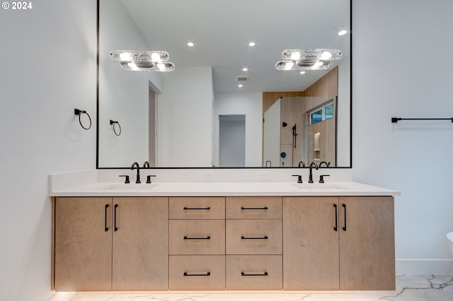 full bathroom featuring a sink, marble finish floor, and double vanity