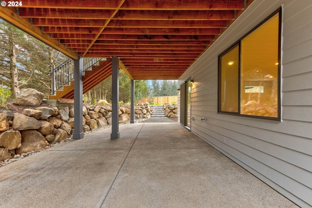 view of patio with stairway and fence