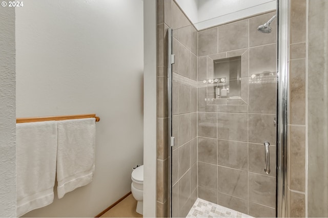 bathroom with toilet and an enclosed shower