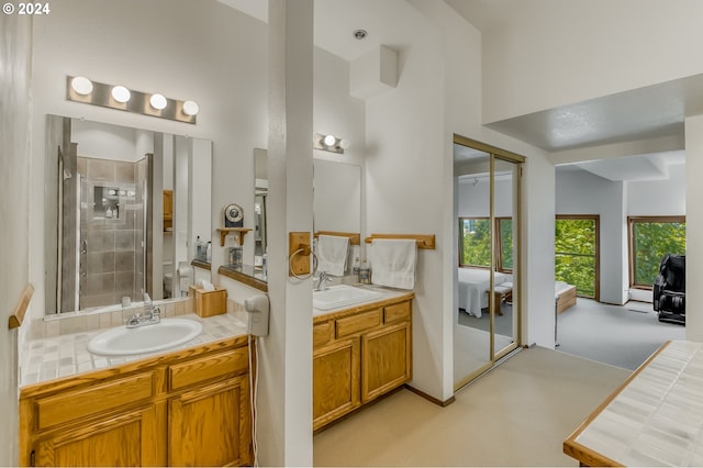 bathroom with vanity, a shower with shower door, and a towering ceiling