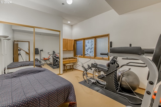 bedroom featuring light carpet and a closet