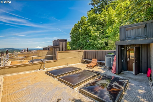 view of patio / terrace with a mountain view and cooling unit