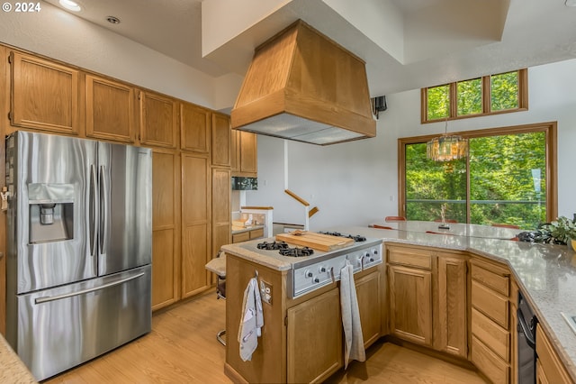 kitchen with gas stovetop, stainless steel fridge with ice dispenser, kitchen peninsula, custom range hood, and light wood-type flooring