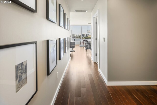 hallway with hardwood / wood-style floors