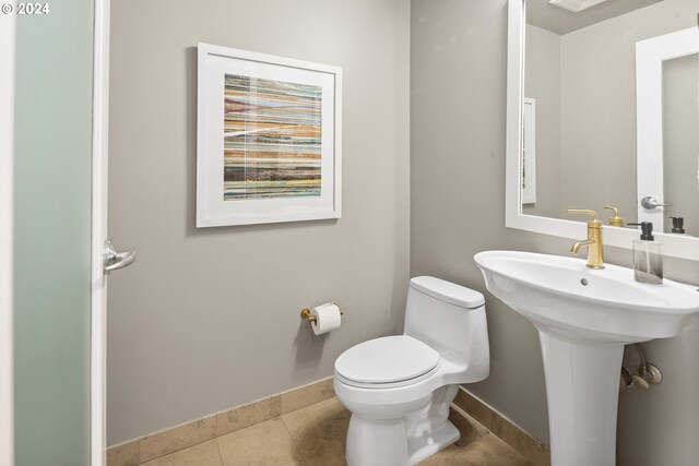 bathroom featuring tile patterned flooring, sink, and toilet